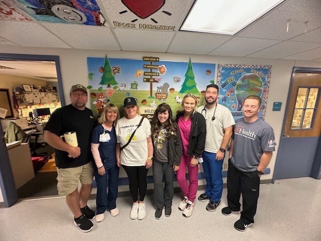 Family group photo with hospital staff at Dance Marathon